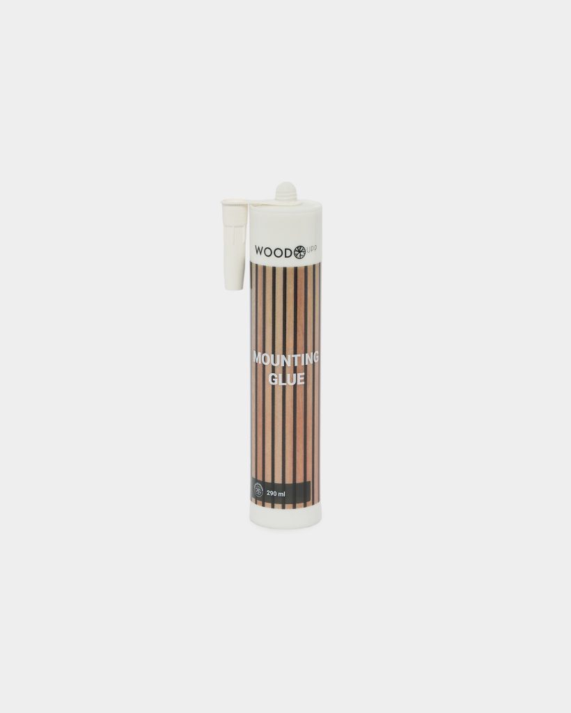 WoodUpp Mounting Glue 290 ml cartridge standing upright on a white background, cylindrical tube with white screw cap and attached applicator nozzle. Label features vertical wood-grain stripes, the WoodUpp logo at top and bold "MOUNTING GLUE" text, designed for adhesive mounting and woodworking applications.
